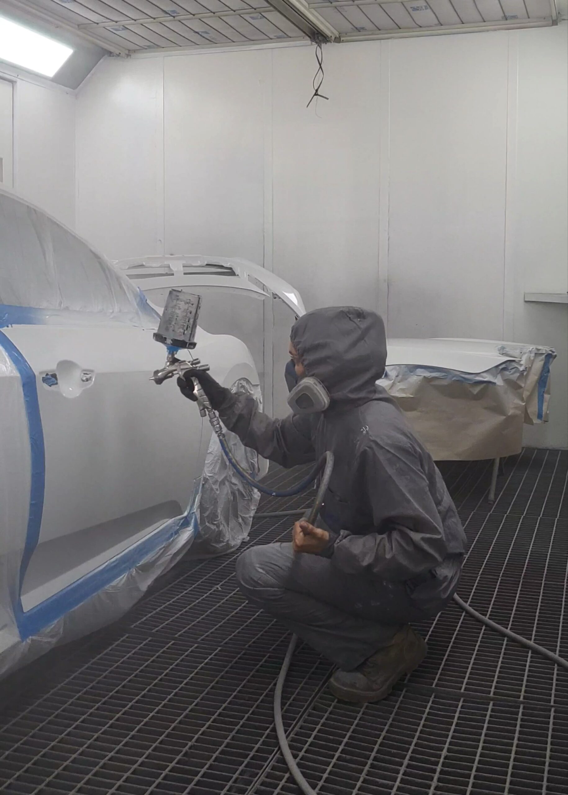 Maddie spraying a car