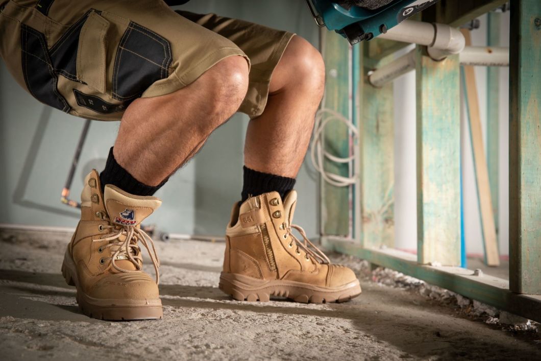 workman in shorts and steel blue boots