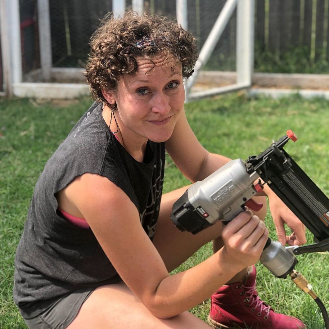 Emily Reed holding a tool while wearing the
